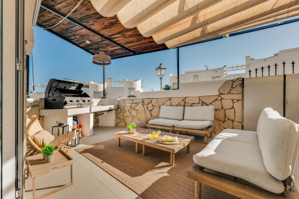 Covered terrace with outdoor lounge and built-in barbecue