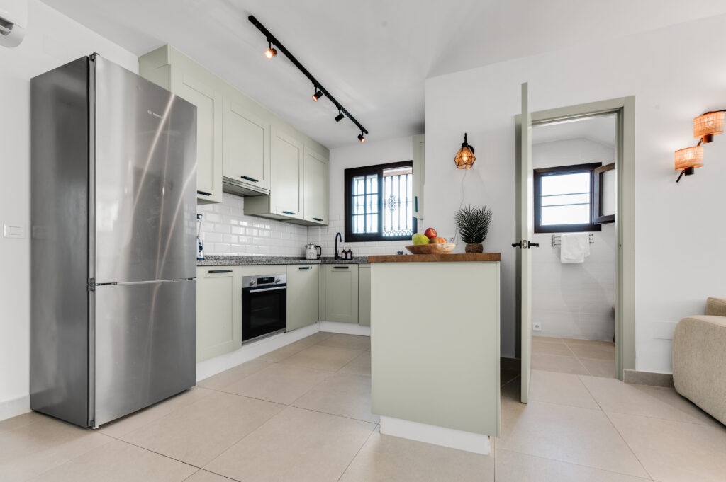 Open kitchen with oven, induction hob and a breakfast bar