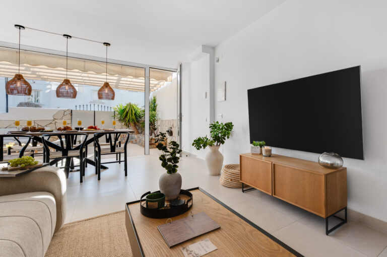 Living area with Smart TV, looking through to the dining table and terrace