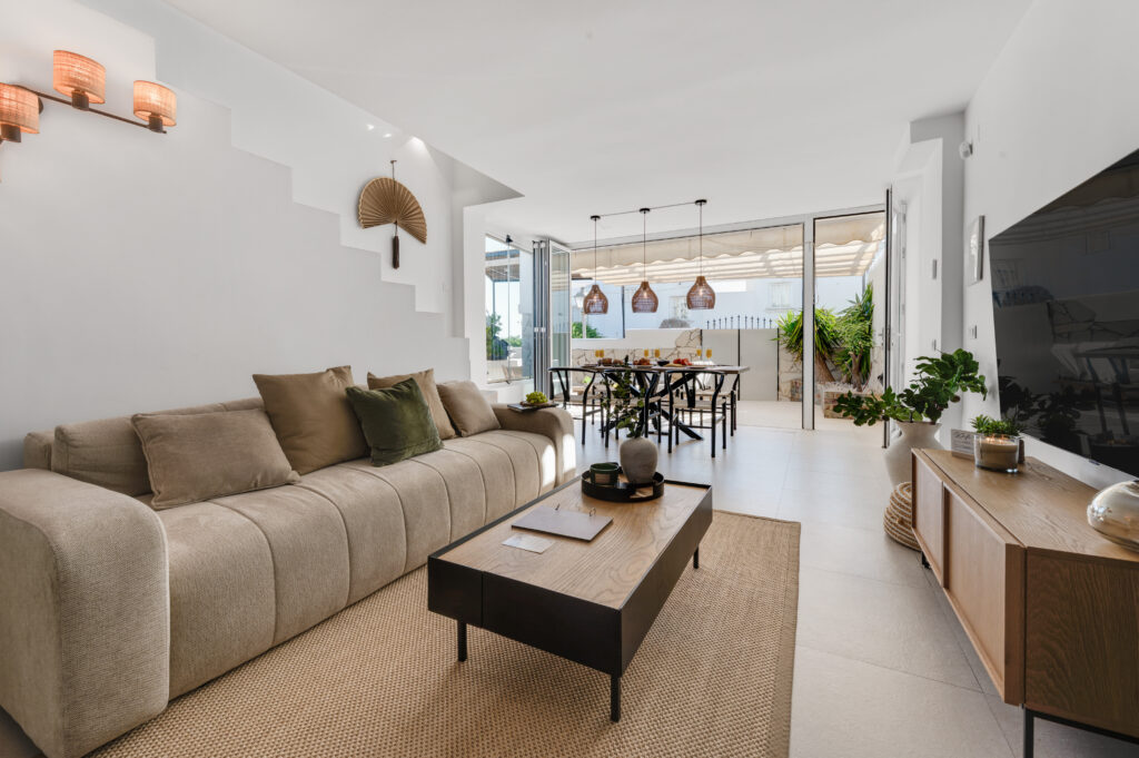 Living room at Casa Cabopino Retreat with the glass doors open to the terrace