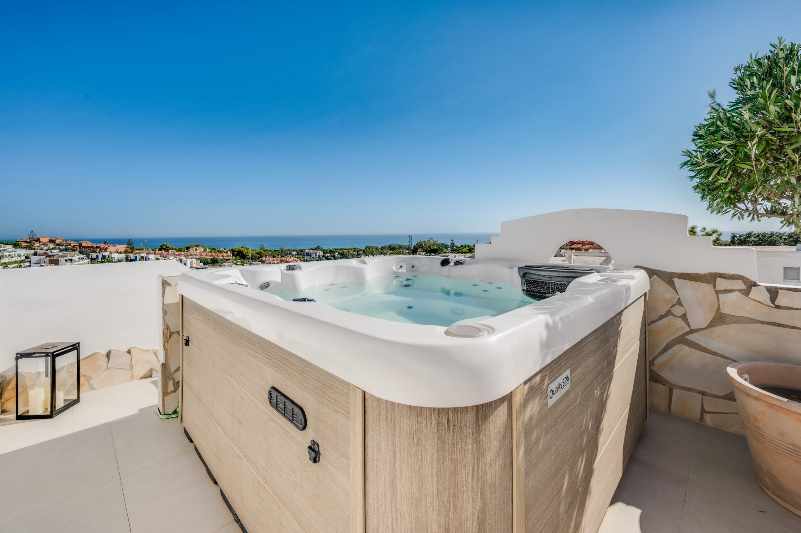 The private heated rooftop jacuzzi of Casa Cabopino Retreat with the Mediterranean on the horizon