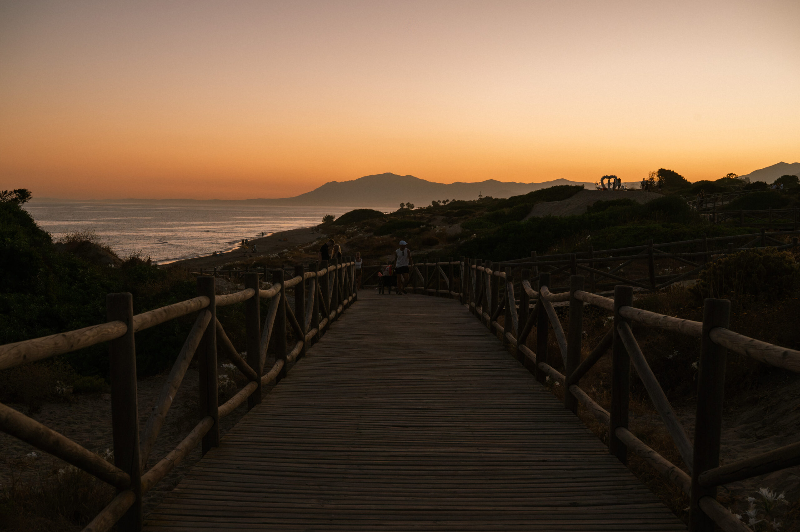 The wooden boardwalk through the protected Dunas de Artola leading to Cabopino beach at sunset, a short walk from Casa Cabopino Retreat