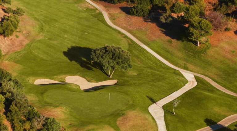 A green and bunker on a golf course a few minutes from Casa Cabopino Retreat in Cabopino, Marbella East