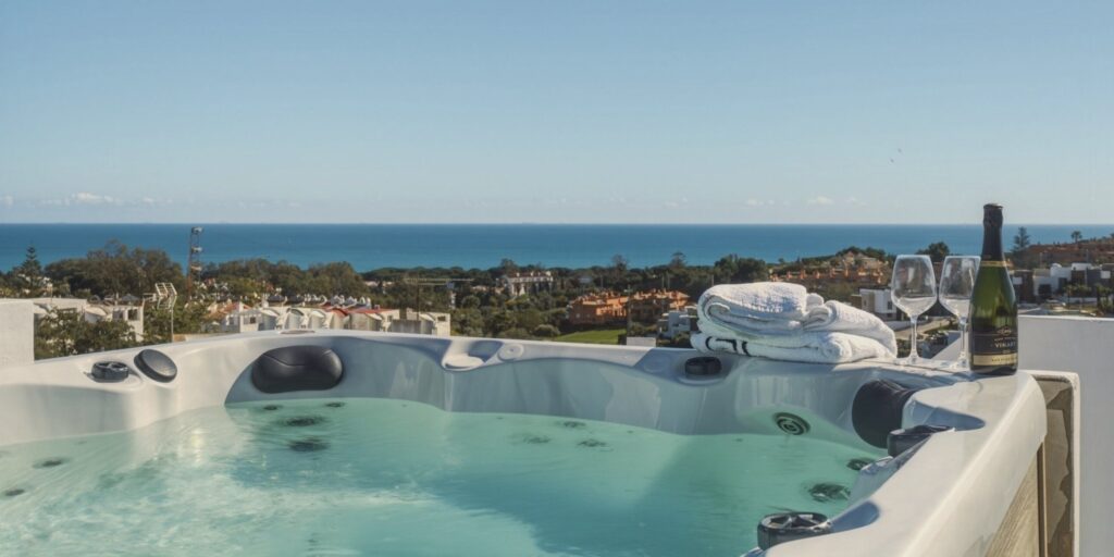 The private rooftop jacuzzi at Casa Cabopino Retreat with a view over the rooftops towards the Mediterranean