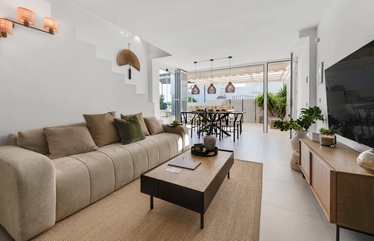 Open living and dining area with the terrace doors folded back at Casa Cabopino Retreat