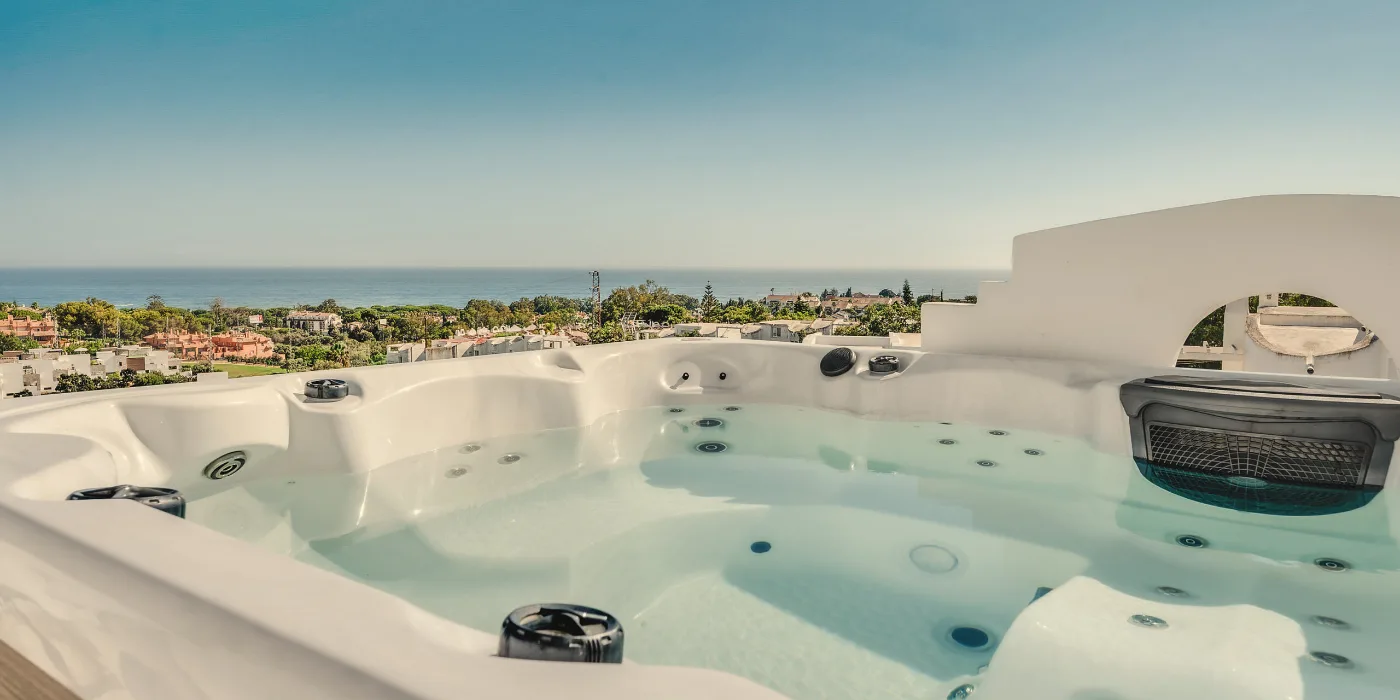 Private heated rooftop jacuzzi at Casa Cabopino Retreat looking out over Artola to the Mediterranean